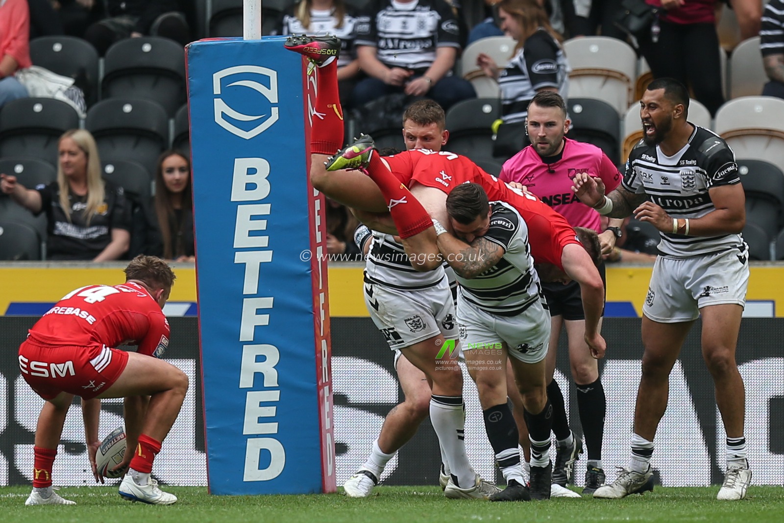 Jamie Shaul (29) of Hull FC lifts Will Maher (26) of Hull KR over his shoulder