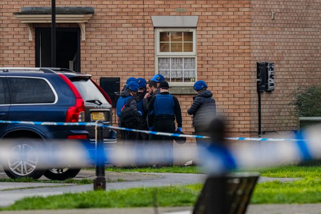 Officers with ordinance unit vests and a dog about to enter an address on Vulcan Street, during a Major Explosives Incident in Derby that began on Thursday December 4 when police executed a warrant at an address on Vulcan Street, Derby, that saw two men arrested on suspicion of explosives offences and 200 homes evacuated (Maynard Manyowa / News Images)