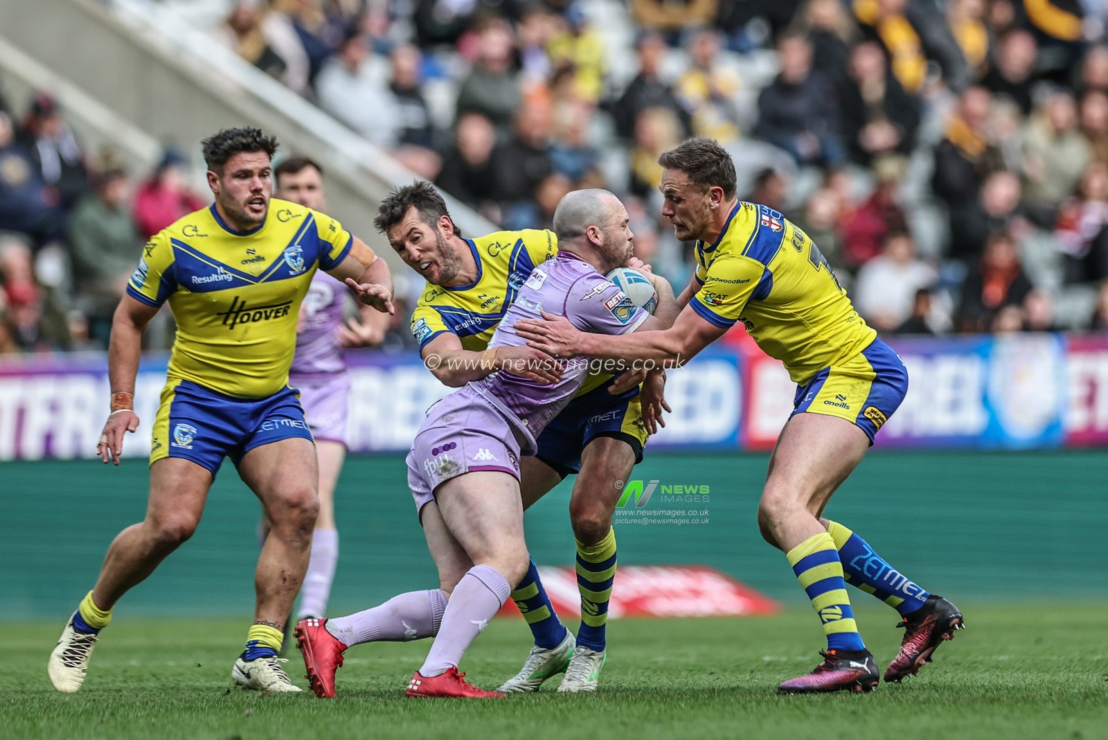 Liam Marshall of Wigan Warriors is tackled by Ben Currie of Warrington Wolves and Stefan Ratchford of Warrington Wolves during the Betfred Magic Weekend 2025 match Wigan Warriors vs Warrington Wolves at St. James's Park, Newcastle, United Kingdom, 4th May 2025

(Photo by Mark Cosgrove/News Images)