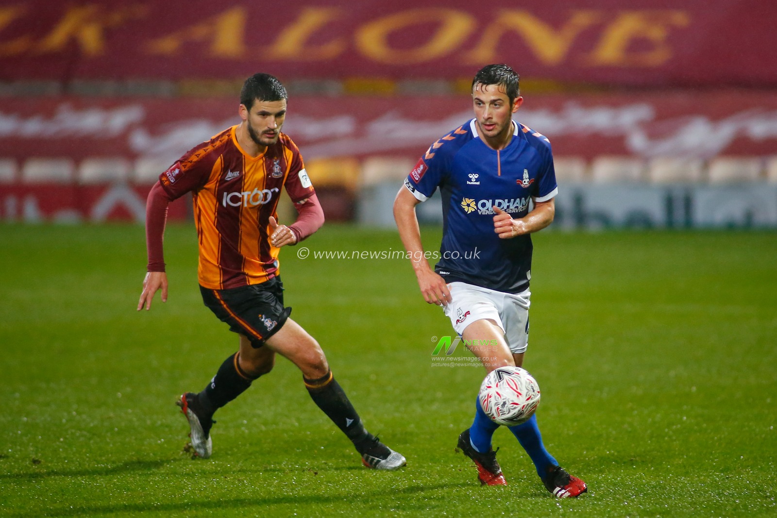 Ben Garrity #6 of Oldham Athletic on the attack against Anthony O'Connor #6 of Bradford City.