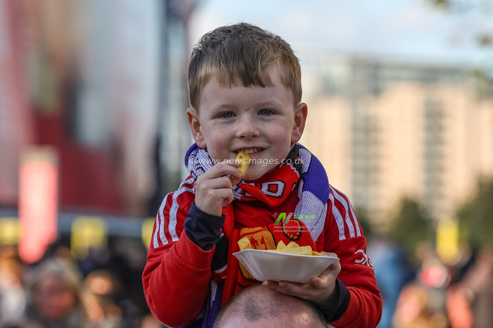 A young Manchester United fan on his dads shoulders eating a tray of chips during the Premier League match Manchester United vs Brighton and Hove Albion at Old Trafford, Manchester, United Kingdom, 25th October 2025

(Photo by Mark Cosgrove/News Images)