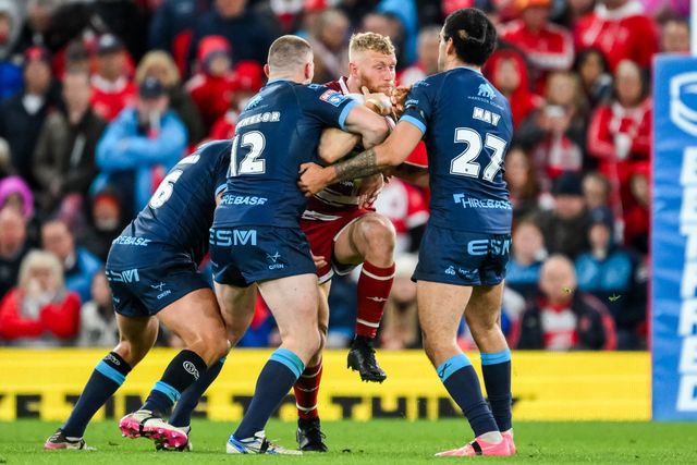 Luke Thompson of Wigan Warriors is tackled by James Batchelor and Tyrone May of Hull KR during the Betfred Super League Grand Final match Wigan Warriors vs Hull KR at Old Trafford, Manchester, United Kingdom, 12th October 2024

(Photo by Craig Thomas/News Images)