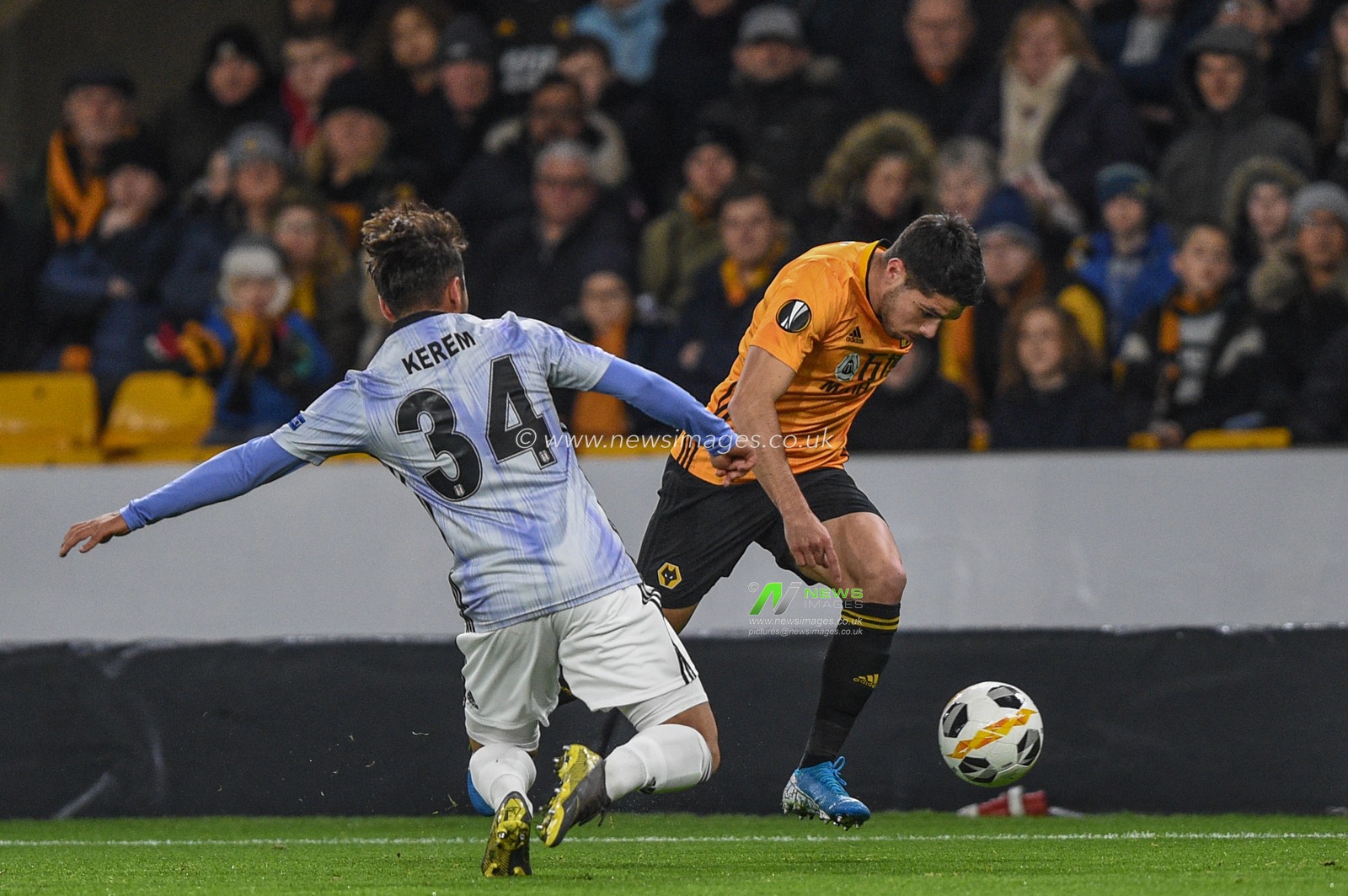 12th December 2019, Molineux, Wolverhampton, England; UEFA Europa League, Wolverhampton Wanderers v Besiktas : Pedro Neto (7) of Wolverhampton Wanderers is tackled by Kerem Kalafat (34) of Besiktas 

Credit: Richard Long/News Images