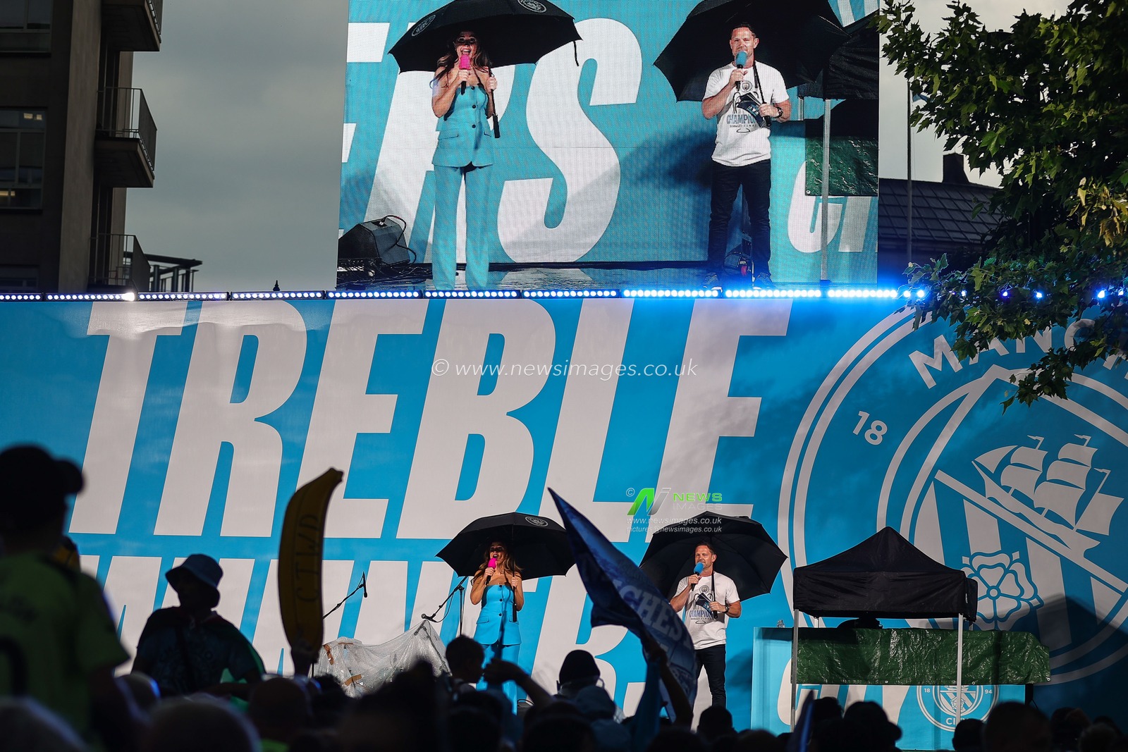 Danny Jackson and Natalie Pike on Stage with umbrellaâ€™s ahead of the Manchester City's Treble victory parade at St Peterâ€™s Square, Manchester, United Kingdom, 12th June 2023

(Photo by Mark Cosgrove/News Images)