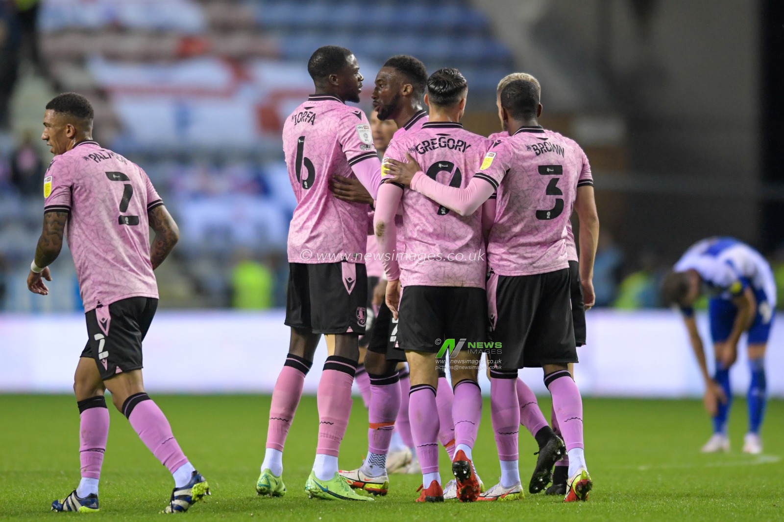 The Sheffield Wednesday players celebrate Max Power #8 of Wigan Athletic scoring an own goal to make it 0-1