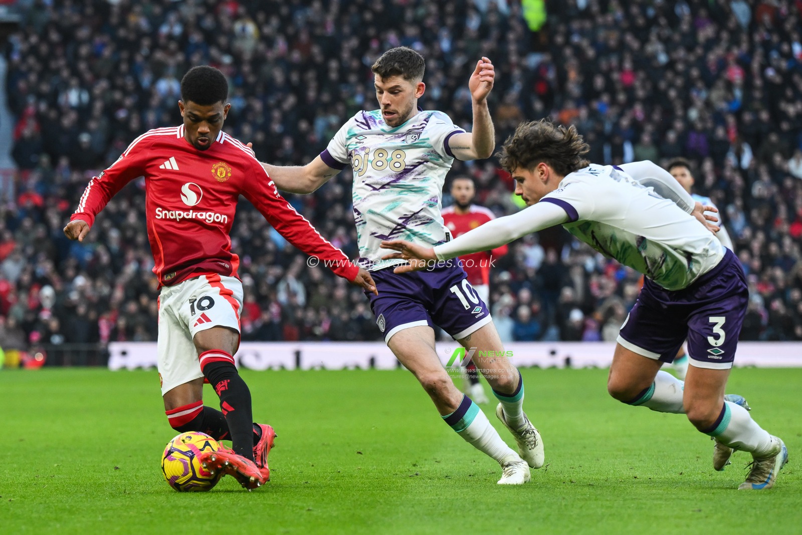 Amad Diallo of Manchester United holds off Ryan Christie of Bournemouth during the Premier League match Manchester United vs Bournemouth at Old Trafford, Manchester, United Kingdom, 22nd December 2024

(Photo by Craig Thomas/News Images)