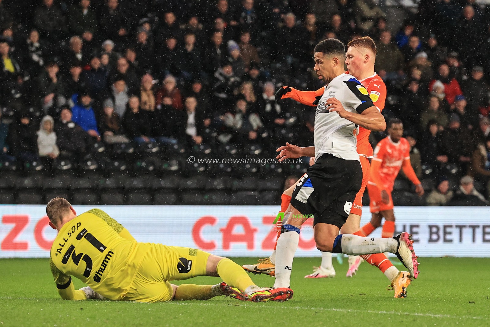 Ryan Allsop #31 of Derby County collects the ball as Sonny Carey #16 of Blackpool is out through