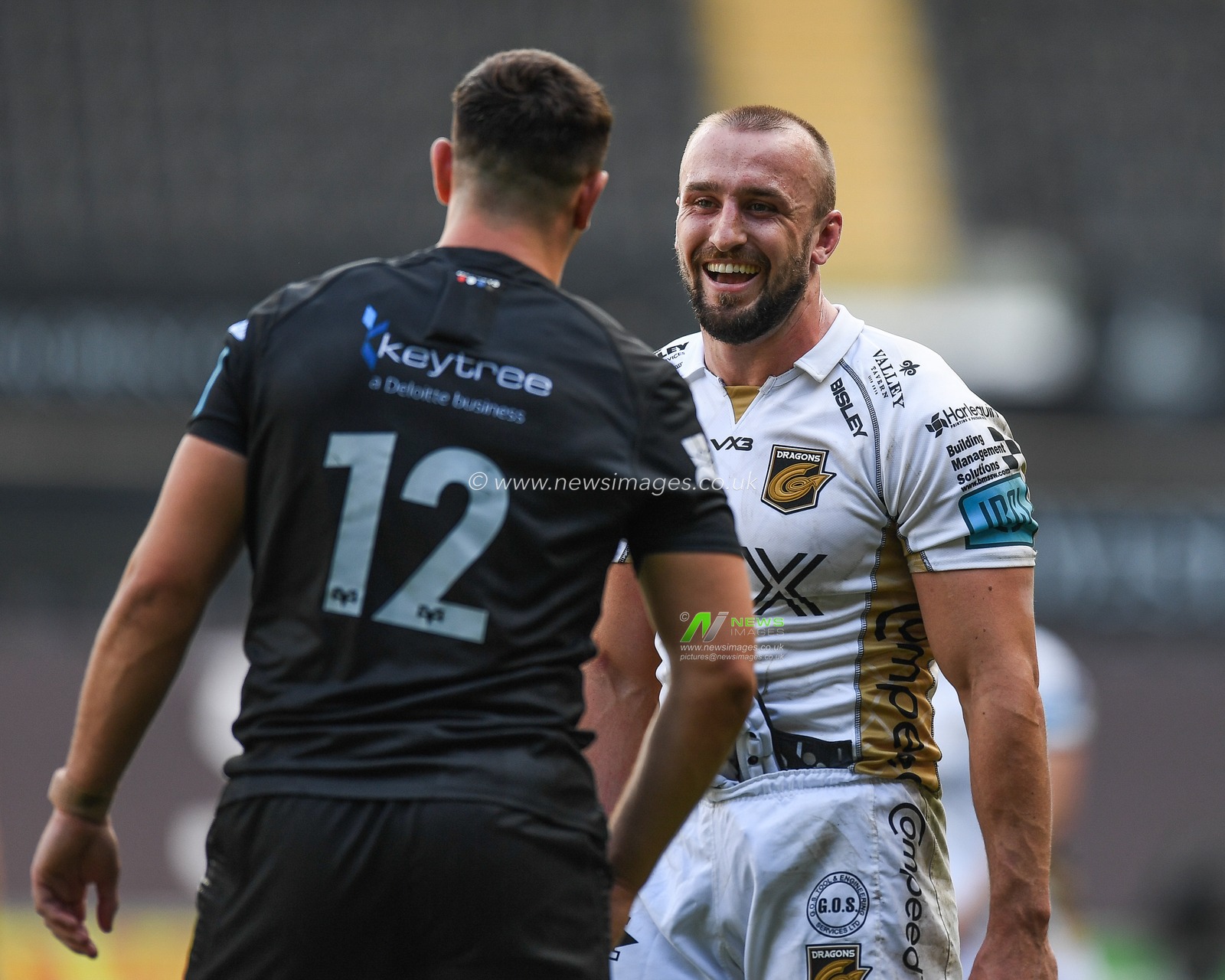 Ollie Griffiths of Dragons, and Owen Watkin of Ospreys, share a joke following the final whistle