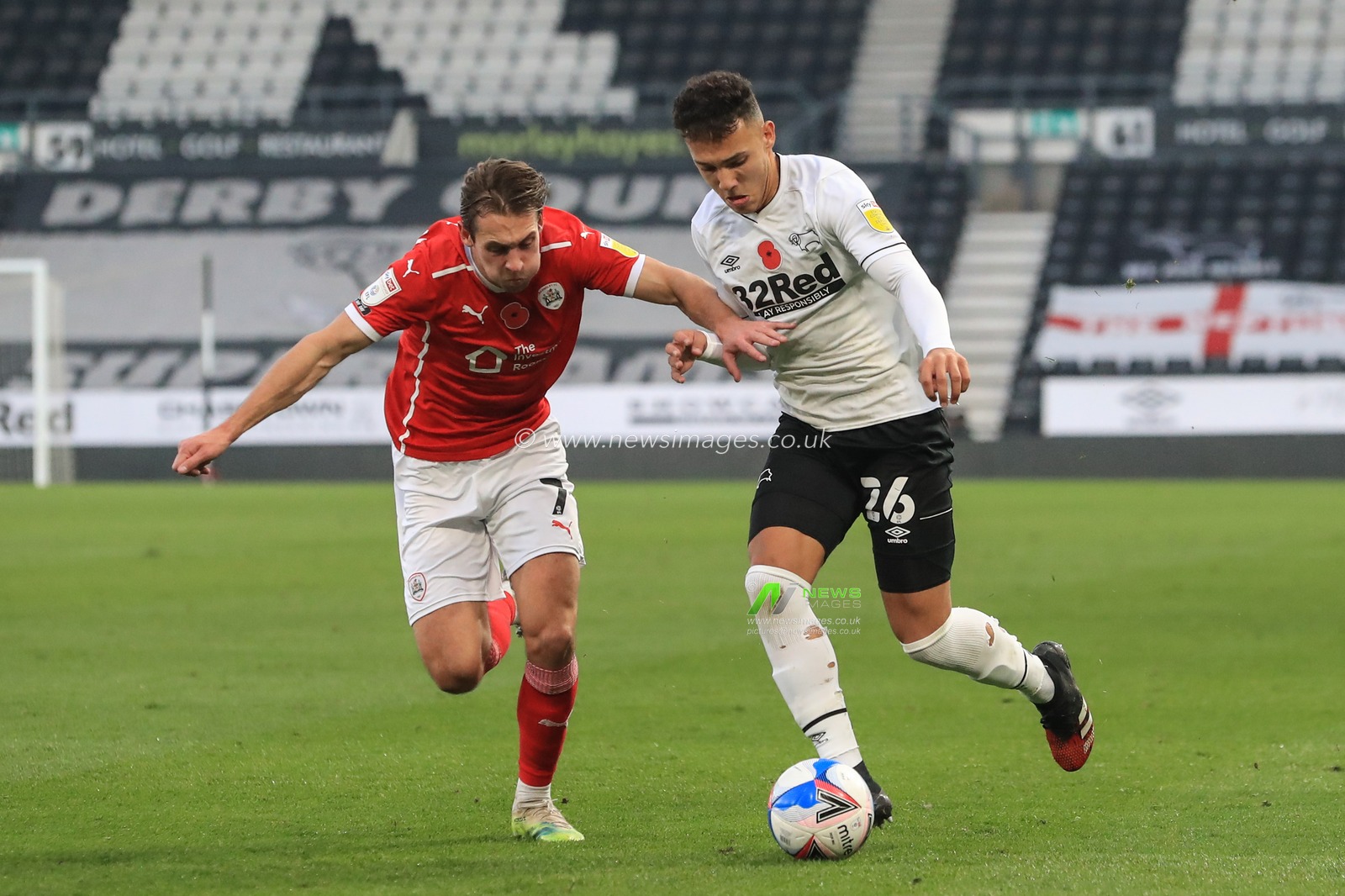 Lee Buchanan #26 of Derby County breaks as Callum Brittain #7 of Barnsley tracks him closely
