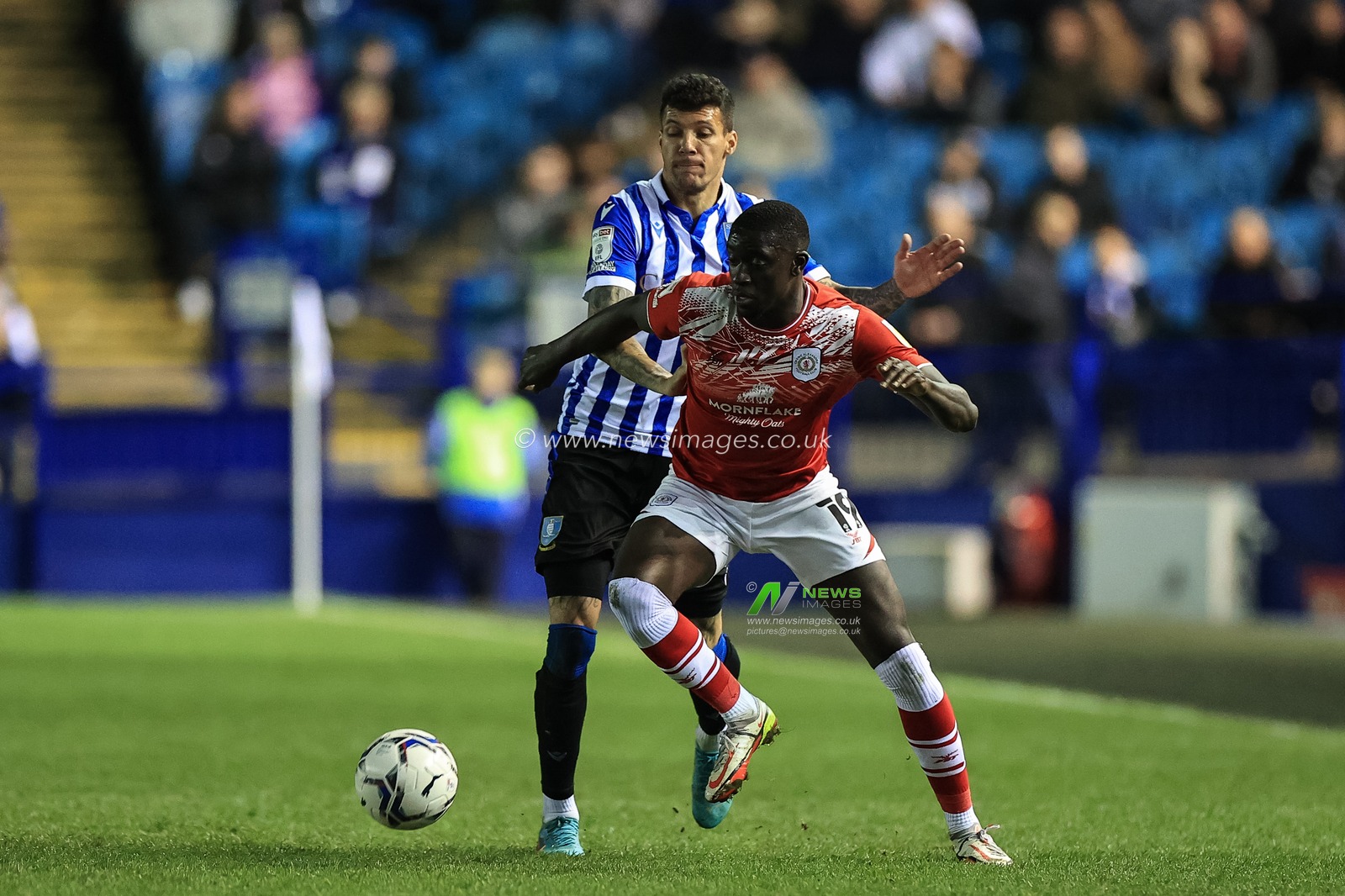 Bassala Sambou #19 of Crewe Alexandra holds off Marvin Johnson #18 of Sheffield Wednesday
