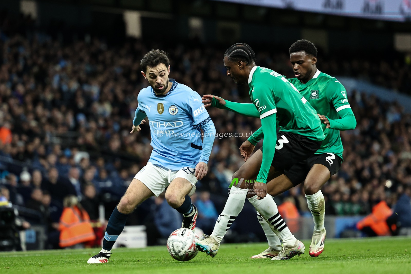 Bernardo Silva of Manchester City is tackled by Nathanael Ogbeta of Plymouth Argyle during the Emirates FA Cup 5th Round match Manchester City vs Plymouth Argyle at Etihad Stadium, Manchester, United Kingdom, 1st March 2025

(Photo by Mark Cosgrove/News Images)