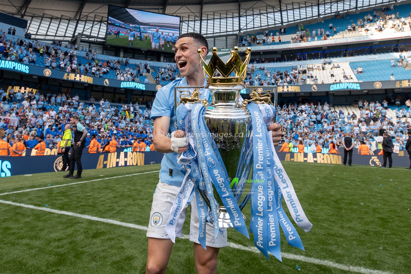 Phil Foden of Manchester City poses with the Barclays Premier League trophy and celebrate in front of his supporters after the Premier League match Manchester City vs West Ham United at Etihad Stadium, Manchester, United Kingdom, 19th May 2024

(Photo by Mark Cosgrove/News Images)