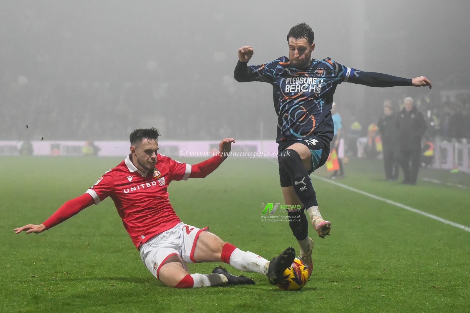 James Husband of Blackpool is tackled by Ryan Barnett of Wrexham during the Sky Bet League 1 match Wrexham vs Blackpool at SToK Cae Ras, Wrexham, United Kingdom, 26th December 2024

(Photo by Craig Thomas/News Images)