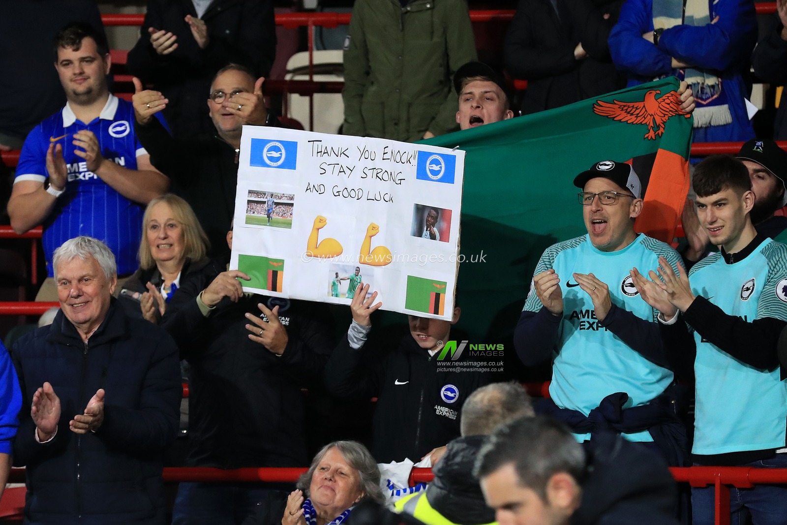 Brighton & Hove Albion fans hold up a placard showing support for Enock Mwepu #8 of Brighton & Hove Albion during the Premier League match Brentford vs Brighton and Hove Albion at Brentford Community Stadium, London, United Kingdom, 14th October 2022

(Photo by Carlton Myrie/News Images)