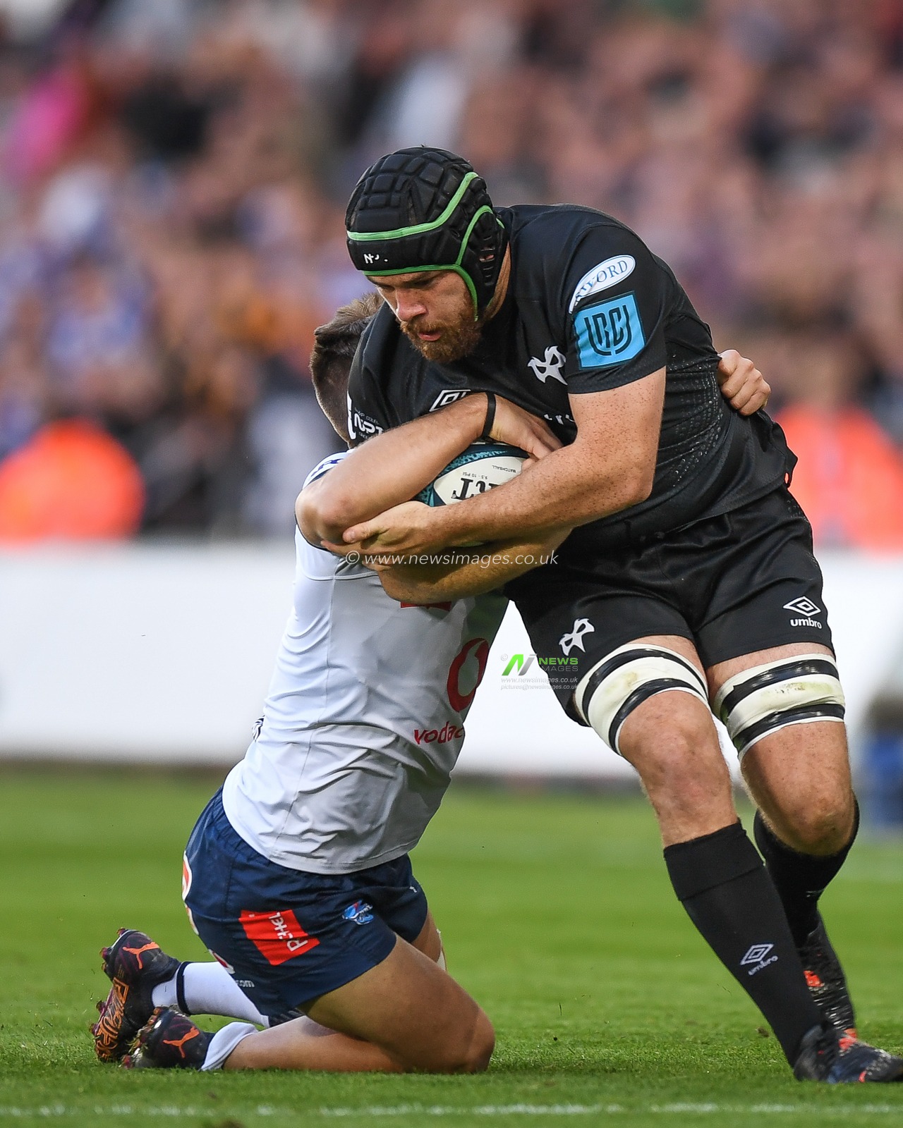 Morgan Morris of Ospreys Rugby, tackled by Zak Burger of Vodacom Bulls,