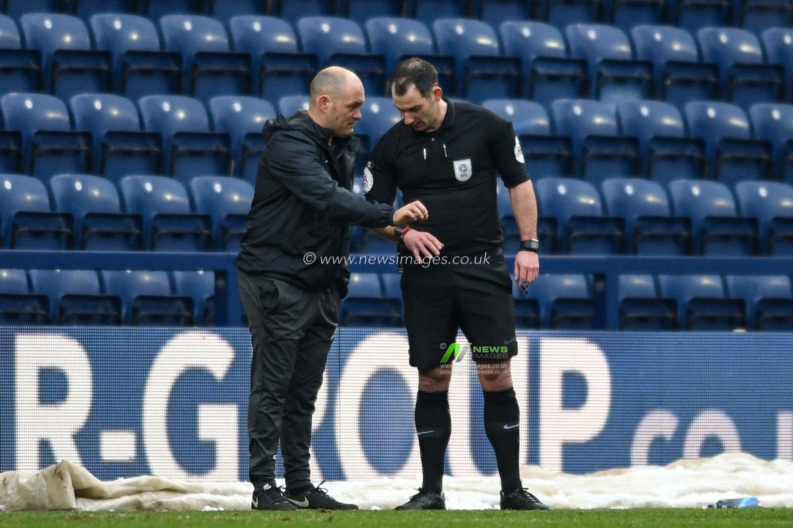 Alex Neil manager of Preston North End speaks to referee Tim Robinson during the game