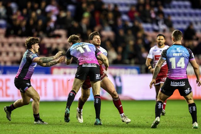 Ethan Havard of Wigan Warriors is tackled by Joe Batchelor of Hull FC and Cade Cust of Hull FC during the Betfred Super League match Wigan Warriors vs Hull FC at The Brick Community Stadium, Wigan, United Kingdom on 21 February 2026

(Photo by Alfie Cosgrove/News Images)