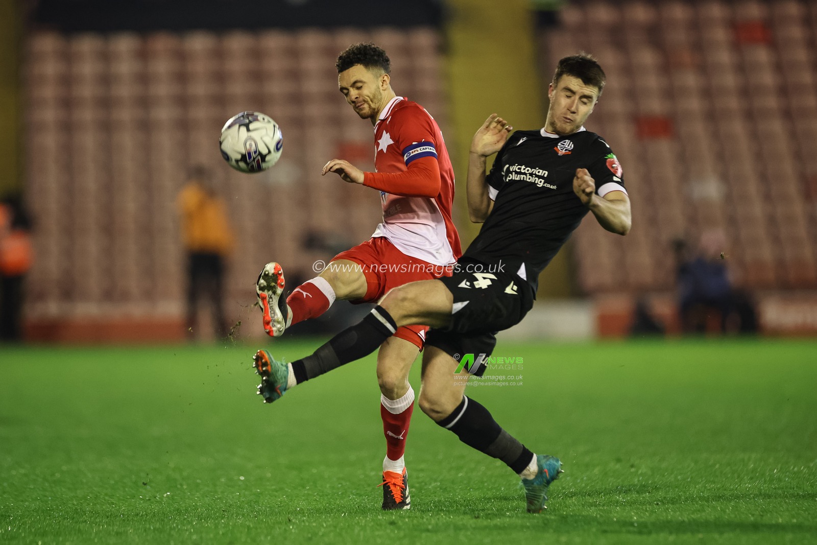 Jordan Williams of Barnsley clears as George Thomason of Bolton Wanderers pressures during the Sky Bet League 1 match Barnsley vs Bolton Wanderers at Oakwell, Barnsley, United Kingdom, 5th March 2024

(Photo by Mark Cosgrove/News Images)