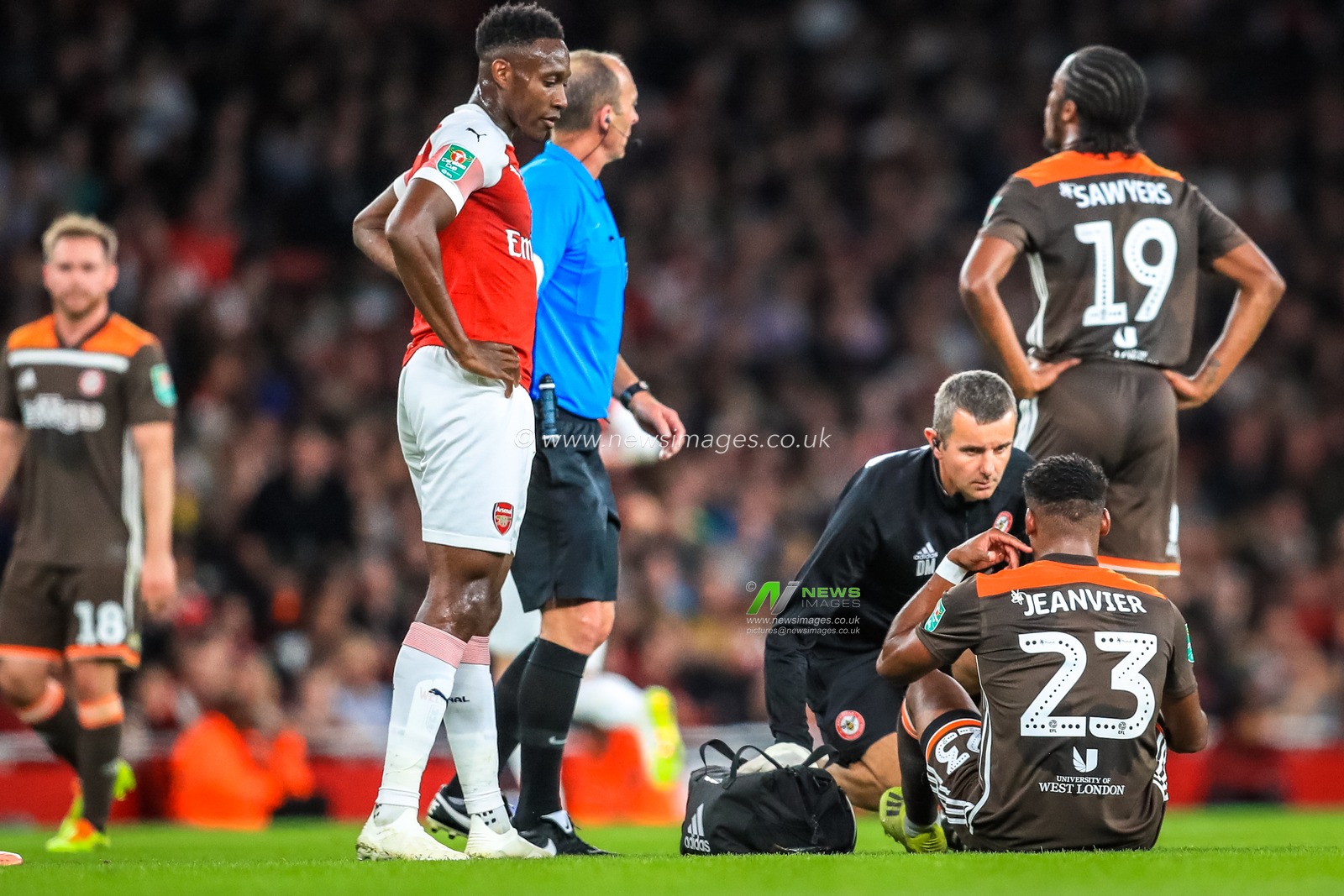 26th September 2018, Emirates Stadium, London, England; Carabao EFL Cup, Third round, Arsenal v Brentford ;  Julian Jeanvier (23) of Brentford receives medical attention.

Credit:  Georgie Kerr/News Images

English Football League images are subject to DataCo Licence