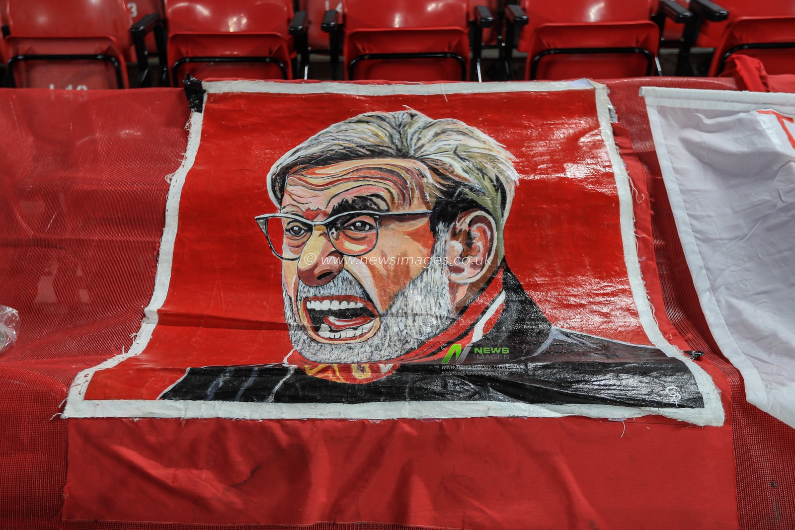 11th March 2020, Anfield, Liverpool, England; UEFA Champions League, Round of 16 Leg 2 of 2, Liverpool v Atletico Madrid : Jurgen Klopp manager of Liverpool sits proudly on a fans banner