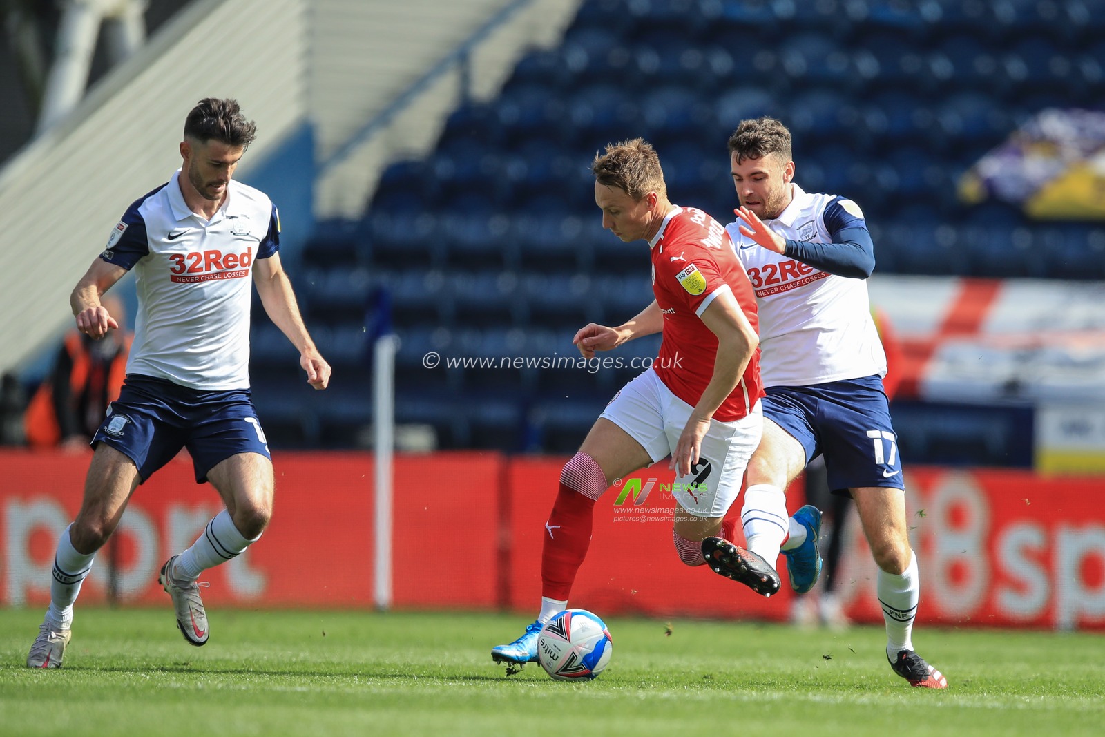 Cauley Woodrow #9 of Barnsley is fouled by Ben Whiteman #17 of Preston North End