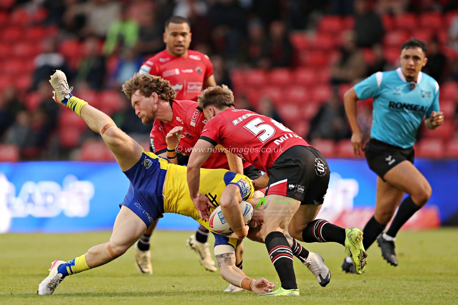 Matt Dufty of Warrington Wolves is tackled by Ethan Ryan of Salford Red Devils and Danny Richardson of Salford Red Devils during the Betfred Super League round 17 match Salford Red Devils vs Warrington Wolves at Salford Community Stadium, Eccles, United Kingdom, 4th July 2025(Photo by Sam Eaden/News Images)
