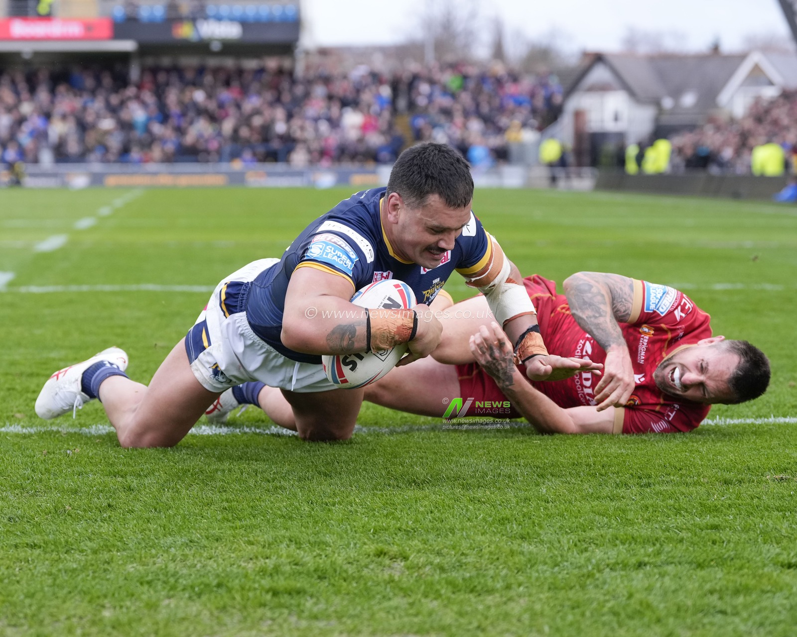 Zane Tetevano #10 of Leeds Rhinos holds off Mitchell Pearce #7 of Catalans Dragons but the try was disallowed during the Betfred Super League Round 6 match Leeds Rhinos vs Catalans Dragons at Headingley Stadium, Leeds, United Kingdom, 25th March 2023

(Photo by Steve Flynn/News Images)