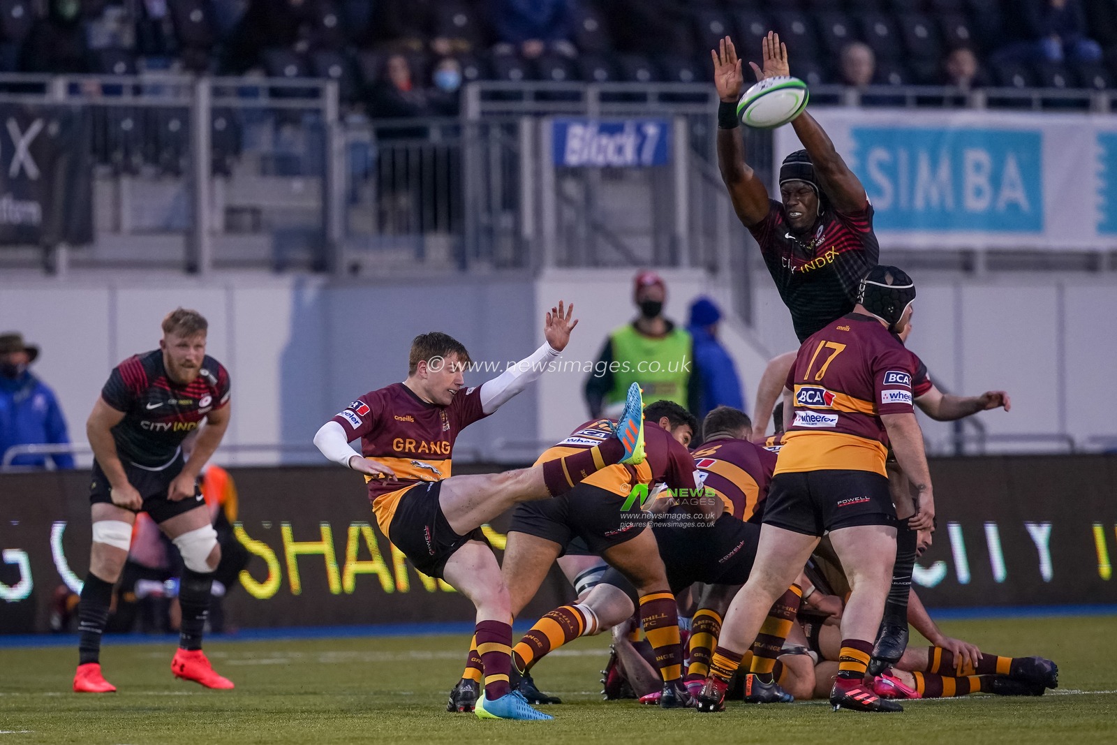 Maro Itoje #4 of Saracens tries to intercept  Will Porter #9 of Ampthill kick.