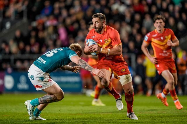 Julian Bousquet of Catalans Dragons is tackled by George Delaney of St Helens during the Betfred Challenge Cup Quarter Final match St Helens vs Catalans Dragons at The BrewDog Stadium, St Helens, United Kingdom on 10 April 2026

(Photo by Maynard Manyowa/News Images)