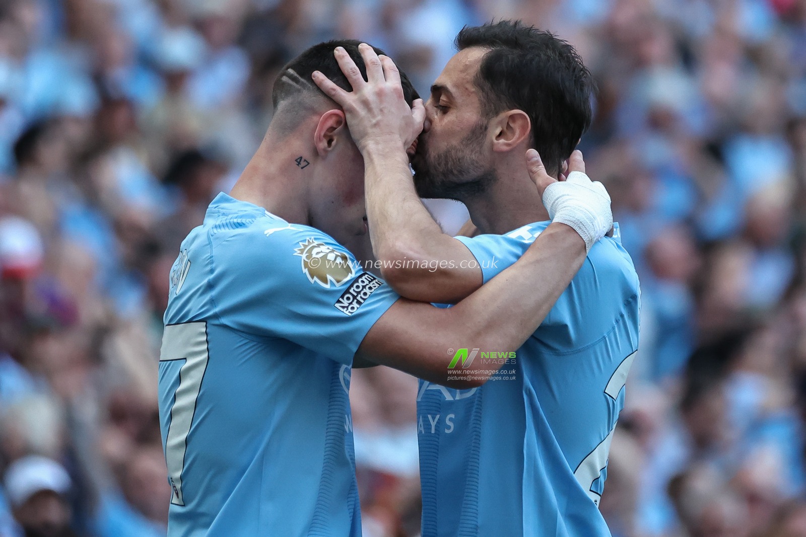Bernardo Silva of Manchester City kisses goalscorer Phil Foden of Manchester City on the head during the celebration during the Premier League match Manchester City vs West Ham United at Etihad Stadium, Manchester, United Kingdom, 19th May 2024

(Photo by Mark Cosgrove/News Images)