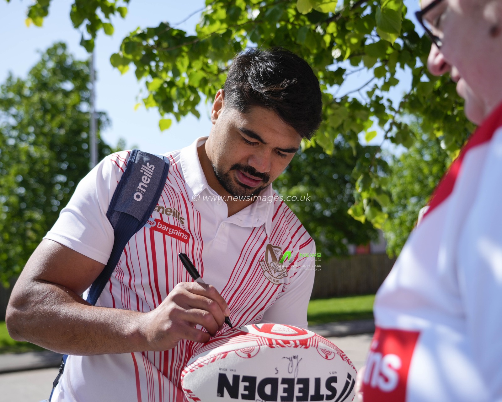 James Bell #19 of St. Helens signs an autograph for a fan before the Betfred Super League Round 12 match St Helens vs Salford Red Devils at Totally Wicked Stadium, St Helens, United Kingdom, 13th May 2023

(Photo by Steve Flynn/News Images)