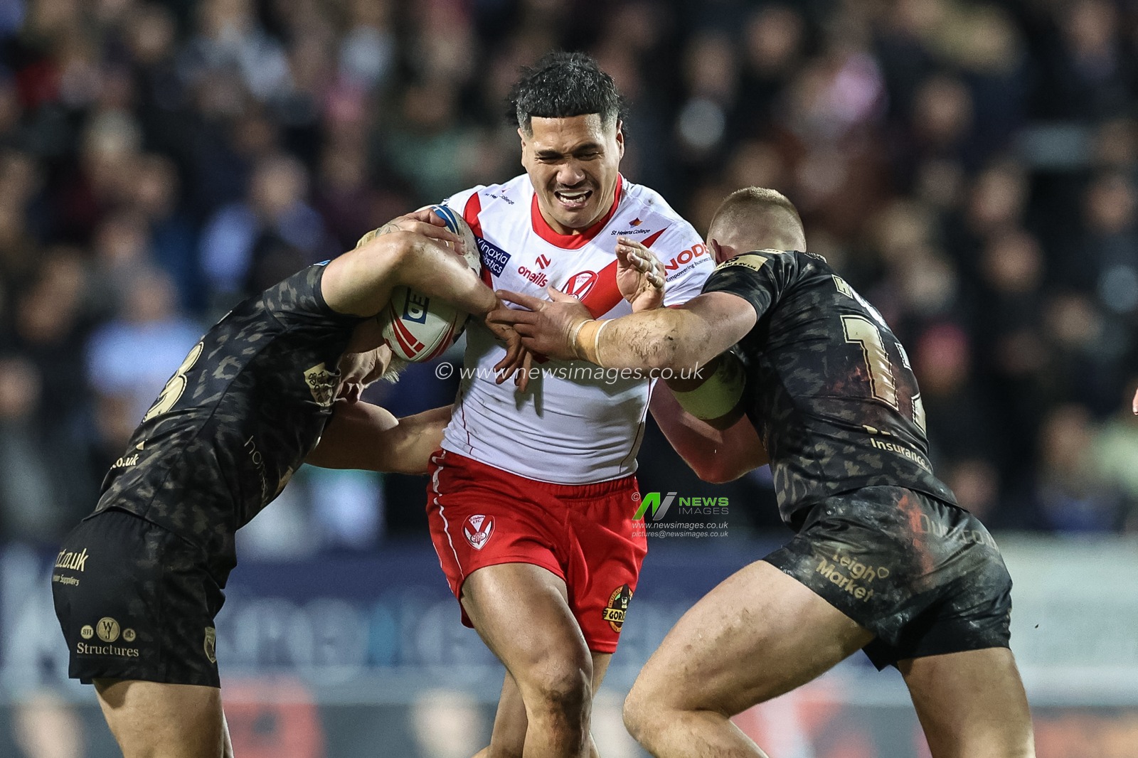 Sione Mataâ€™utia of St. Helens is tackled by Brad Dwyer of Leigh Leopards and Jack Hughes of Leigh Leopards during the Betfred Super League Round 3 match St Helens vs Leigh Leopards at Totally Wicked Stadium, St Helens, United Kingdom, 1st March 2024

(Photo by Mark Cosgrove/News Images)