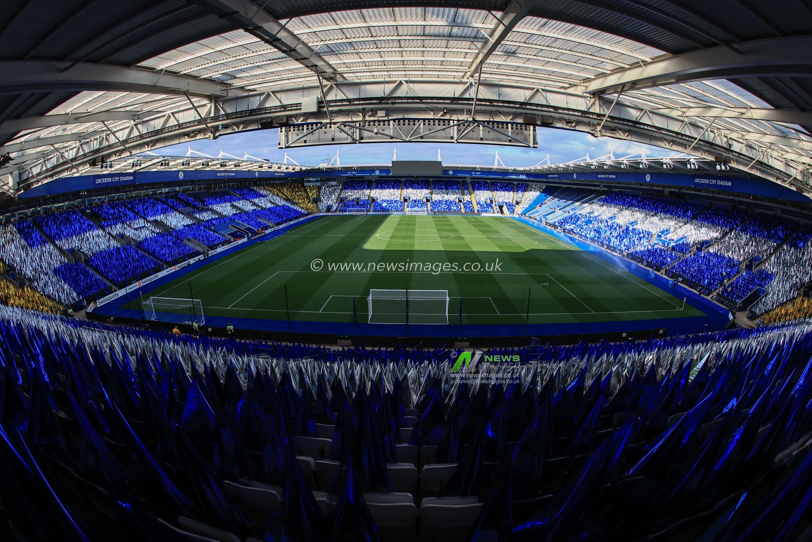 Thousands of blue, silver and gold flags are placed on seats around the King Power Stadium