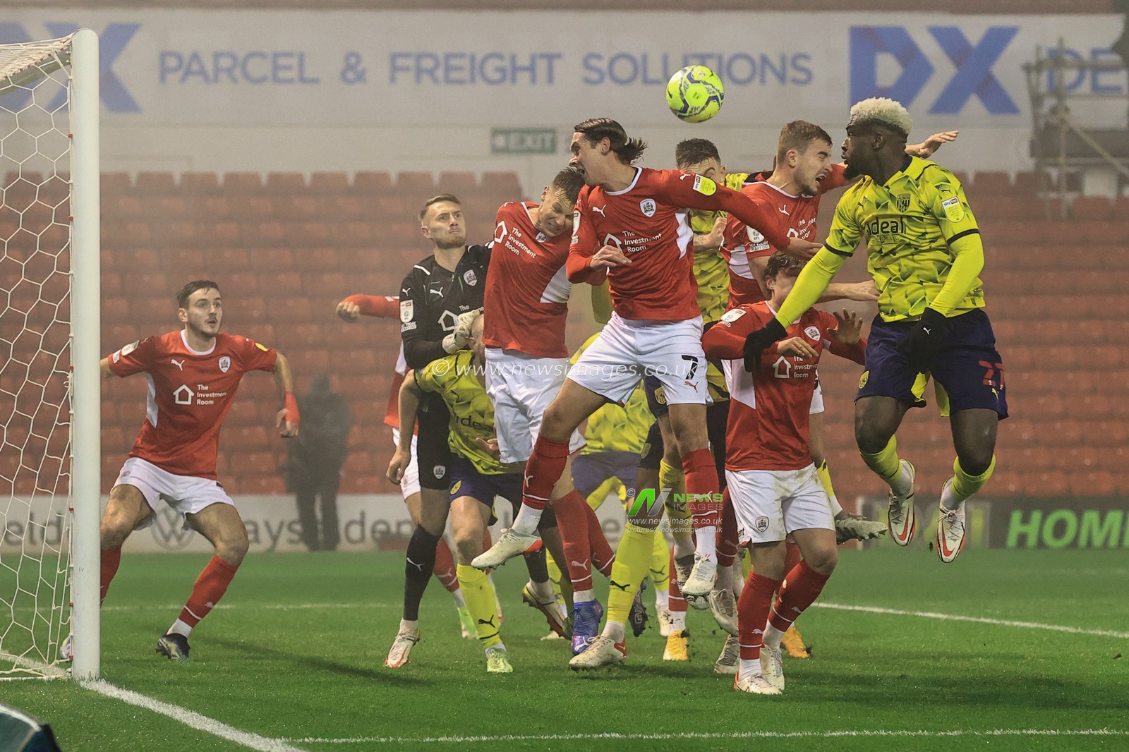 Mads Juel Andersen #6 of Barnsley heads clear from a West Brom corner