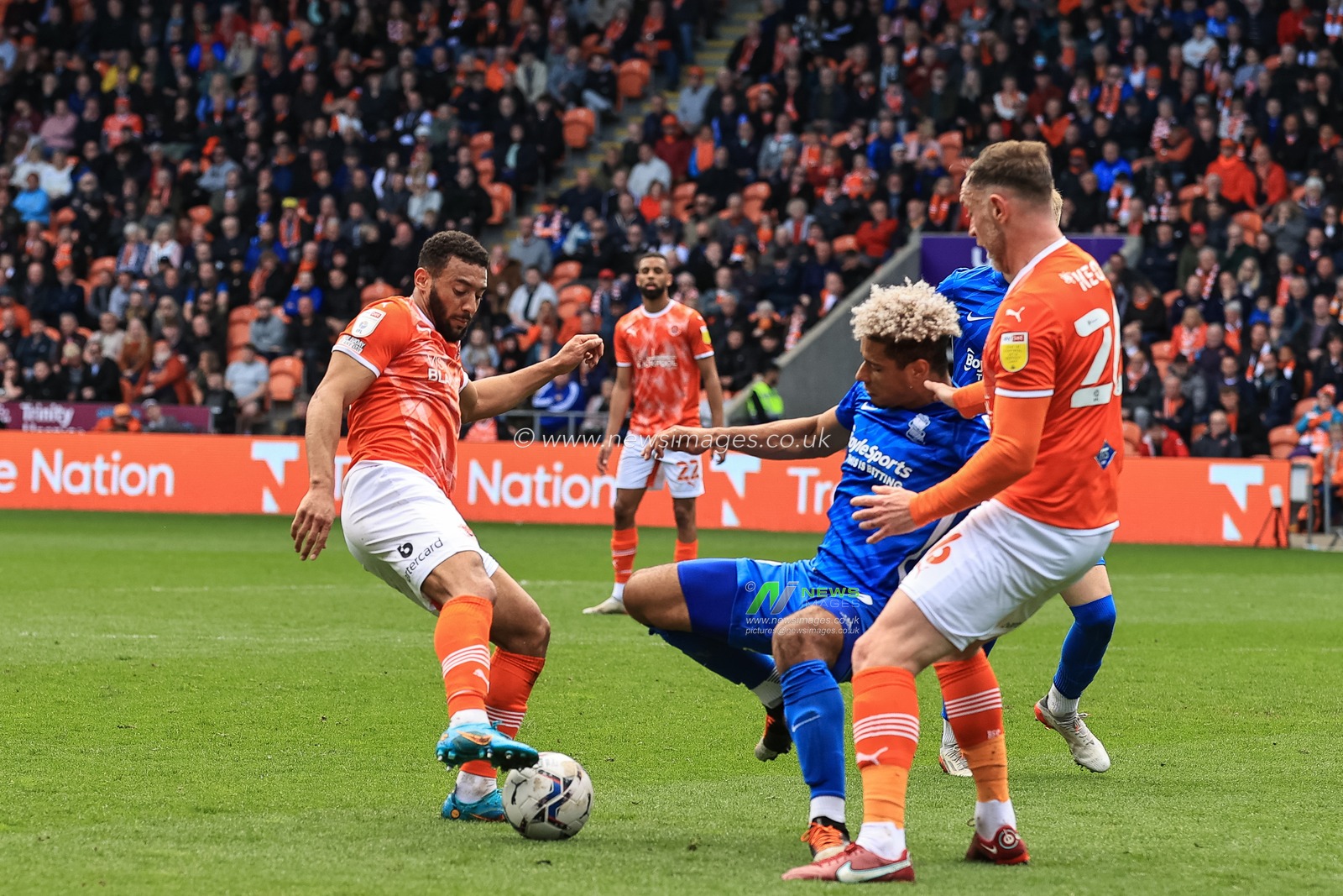 Lyle Taylor #33 of Birmingham City is tackled by Keshi Anderson #10 of Blackpool
