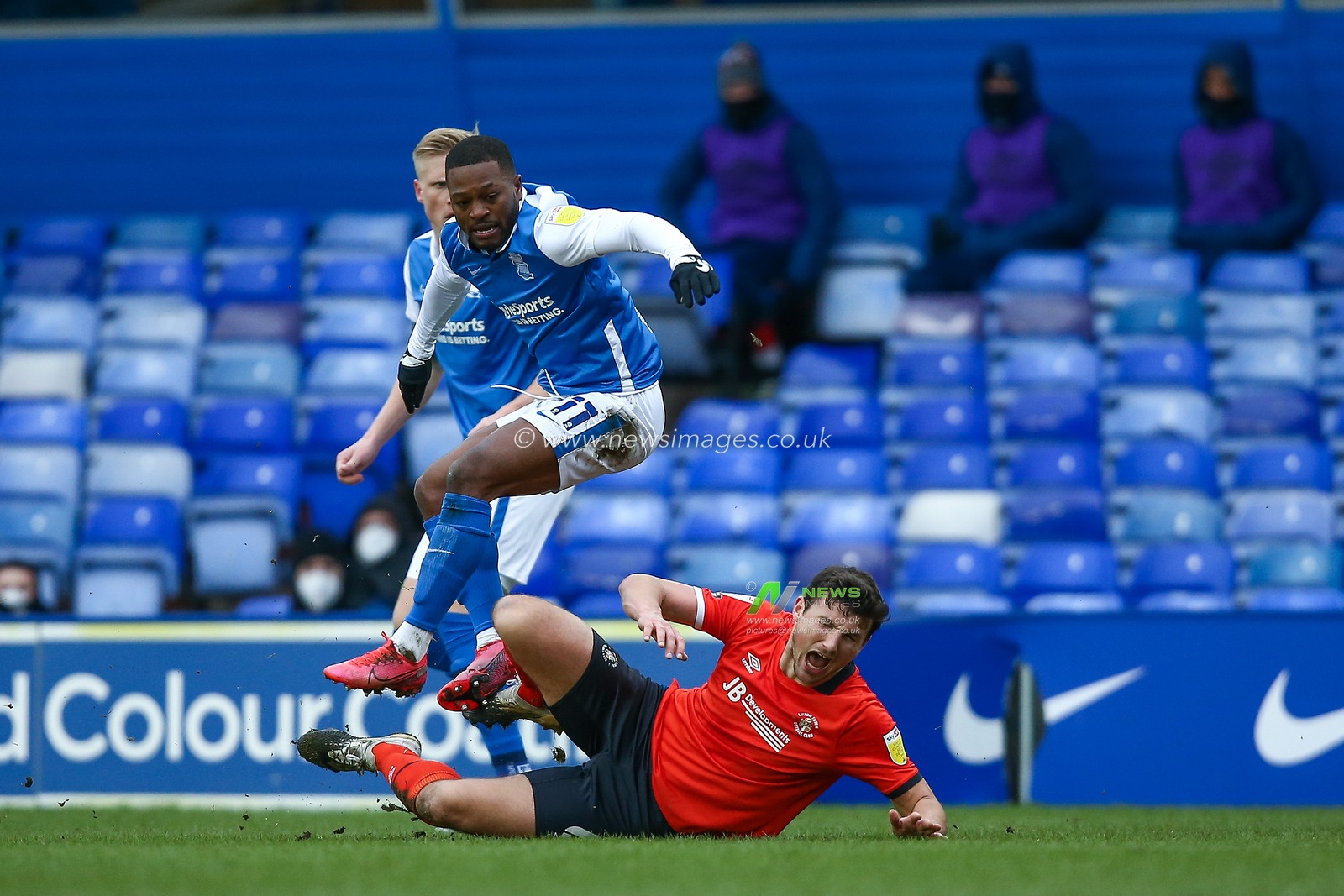Matty Pearson #6 of Luton Town is fouled by Jeremie Bela #11 of Birmingham City