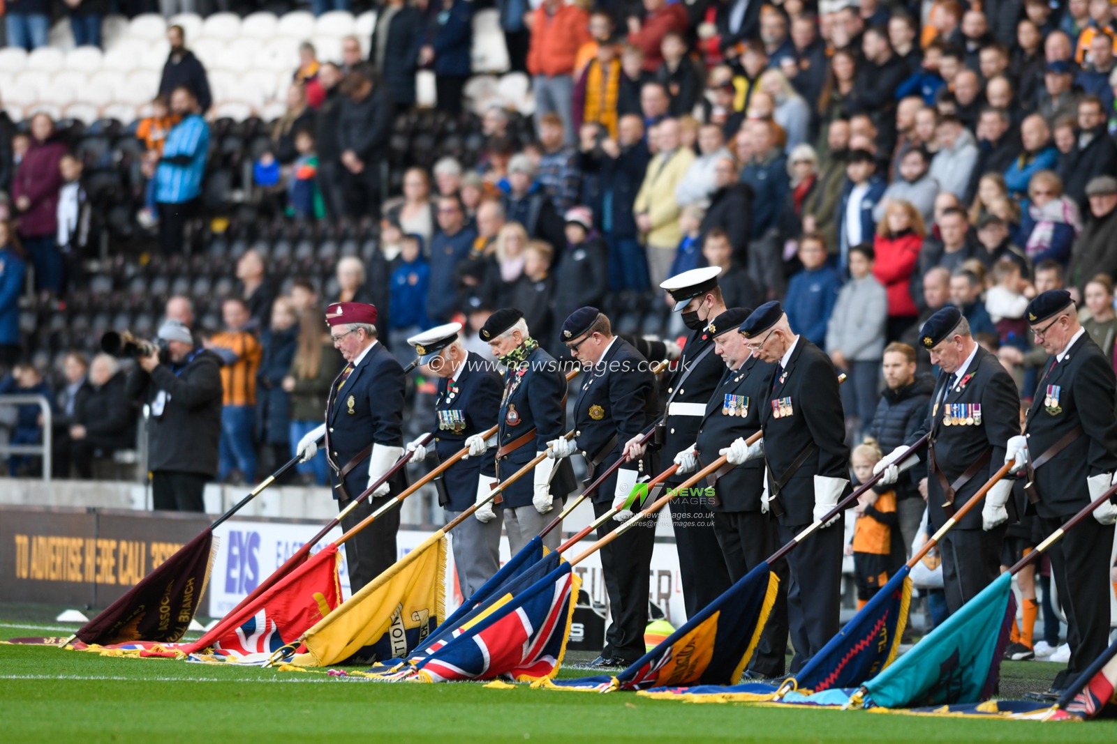 Members of the Royal British Legion lower their flags in remembrance of those who have made the ultimate sacrifice