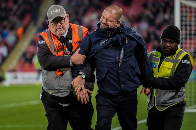 A pitch invader celebrates Yuki Ohashi of Blackburn Rovers scoring to make it 0-2 as security tries to remove him from the pitch during the Sky Bet Championship match Sheffield United vs Blackburn Rovers at Bramall Lane, Sheffield, United Kingdom on 22 April 2026

(Photo by Maynard Manyowa/News Images)