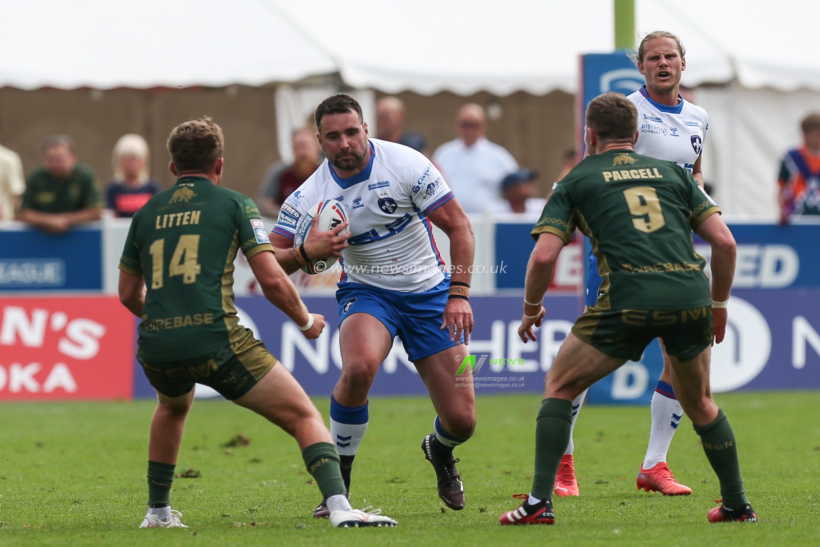 Josh Bowden #37 of Wakefield Trinity runs at Jez Litten #14 and Matt Parcell #9 of Hull KR