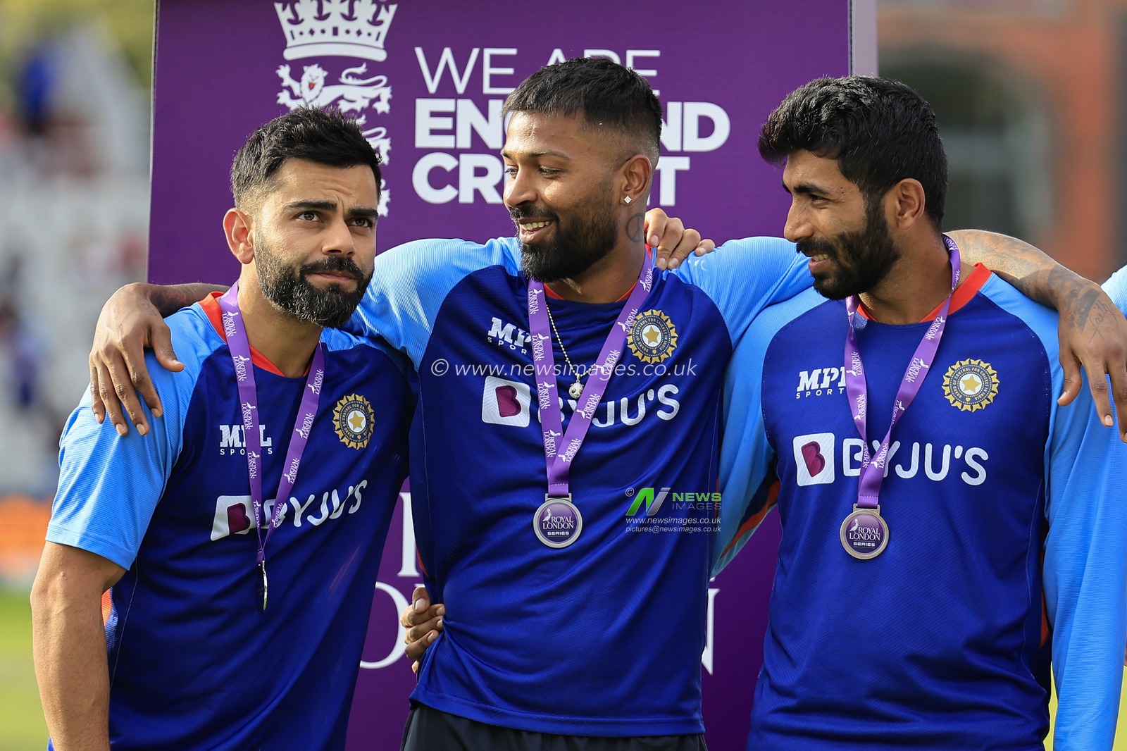 Virat Kohli, Hardik Pandya and Jasprit Bumrah of India on stage at the end of the match