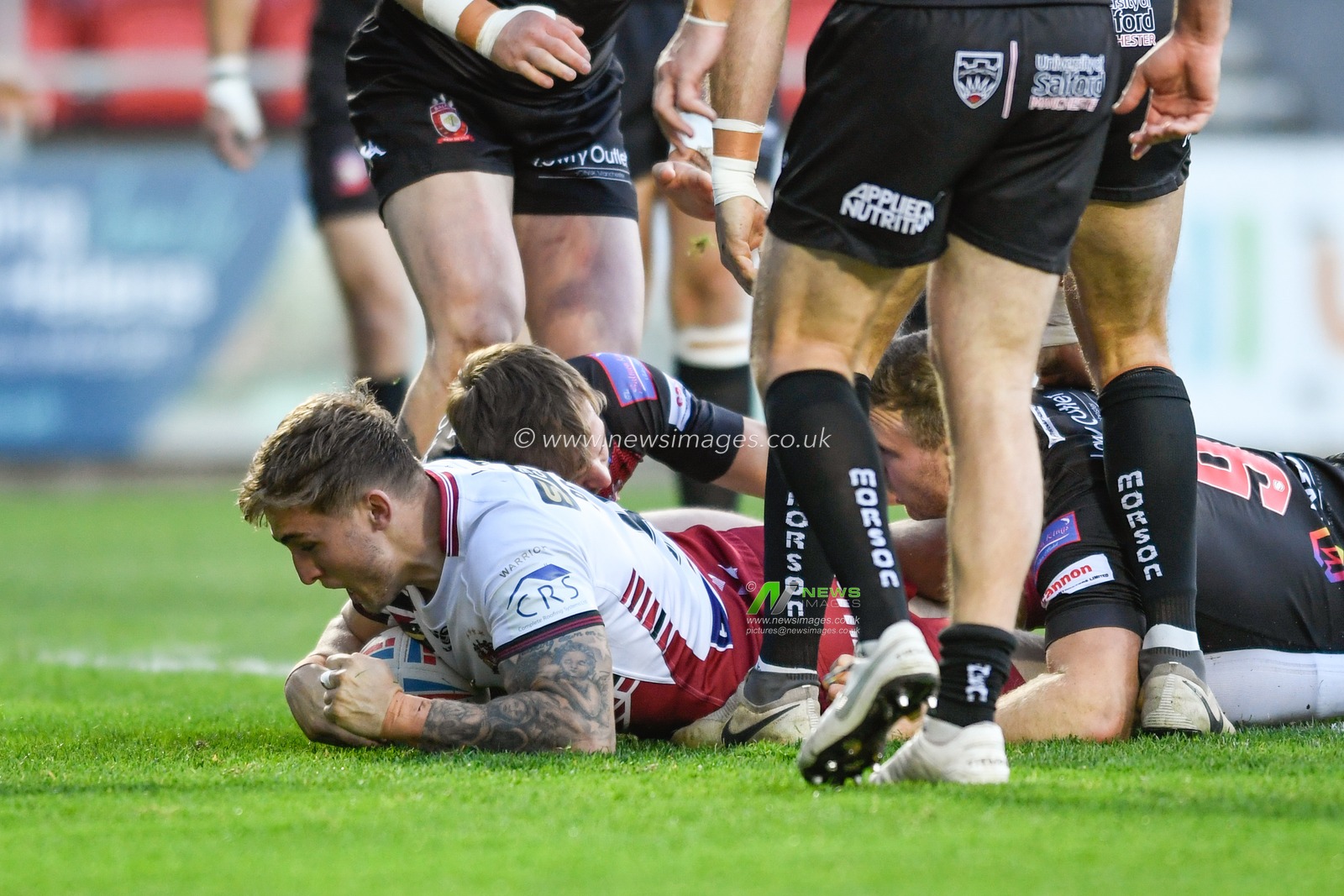Sam Powell (9) of Wigan Warriors goes over for a try