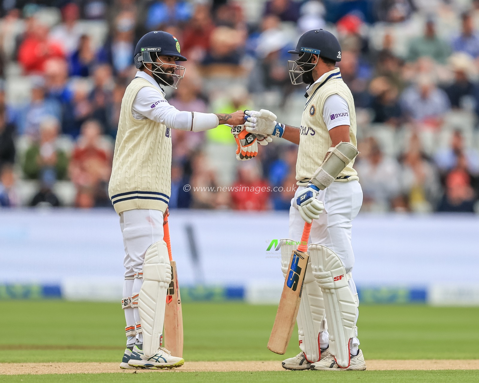 Mohammad Shami of India celebrates a four and gets on. The scoreboard with Ravindra Jadeja of India