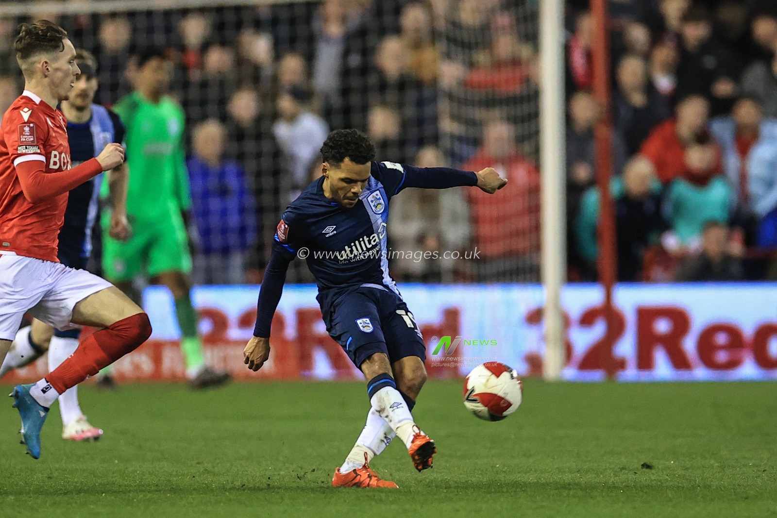 Duane Holmes #19 of Huddersfield Town passes a long ball