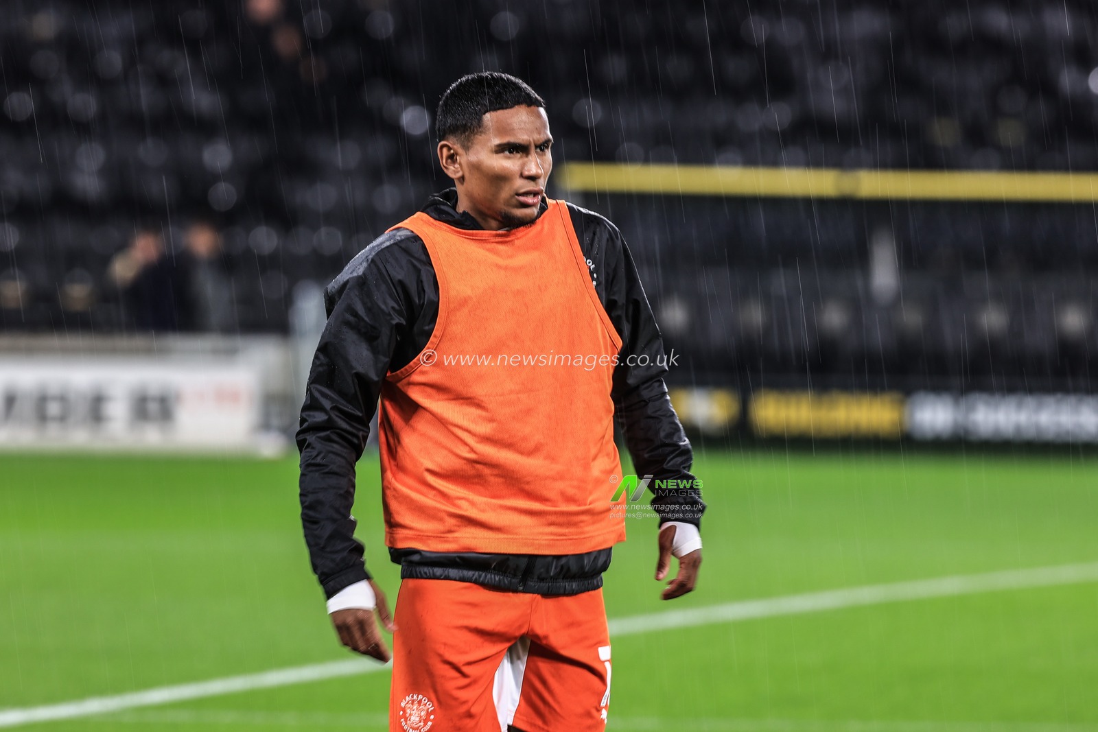 Demetri Mitchell #15 Of Blackpool during the pre-game warmup as the rain pours over the MKM Stadium