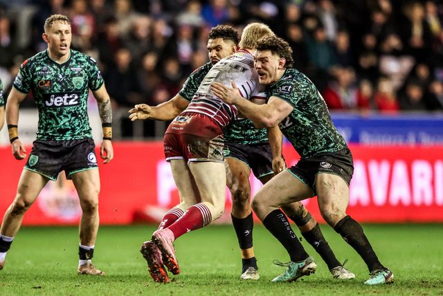 Zach Eckersley of Wigan Warriors is tackled by Robbie Mulhern of Leigh Leopards during the Betfred Super League match Wigan Warriors vs Leigh Leopards at The Brick Community Stadium, Wigan, United Kingdom on 26 February 2026

(Photo by Alfie Cosgrove/News Images)