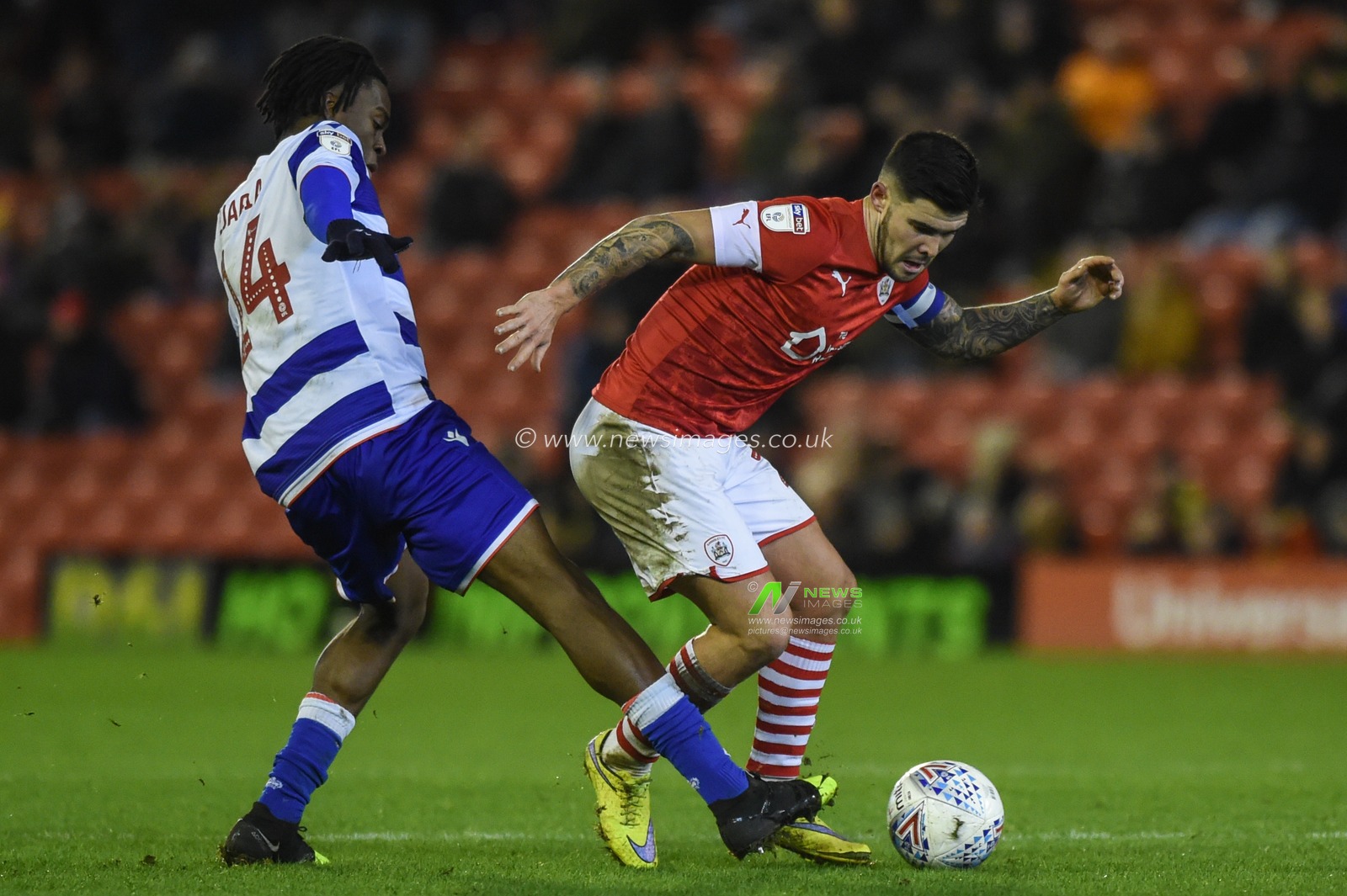 11th December 2019, Oakwell, Barnsley, England; Sky Bet Championship, Barnsley v Reading : Oviemuno Ejaria (14) of Reading FC tackles Mamadou Thiam (26) of Barnsley FC

Credit: Dean Williams/News Images