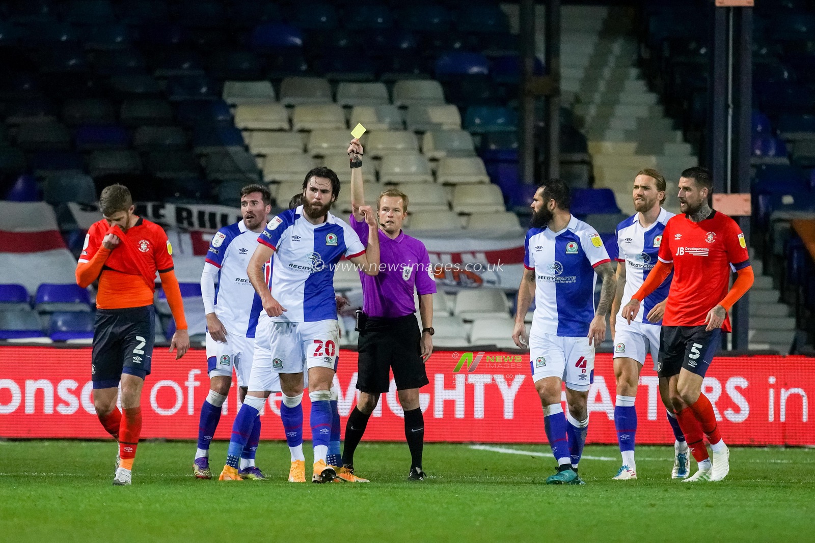 Ben Brereton #20 of Blackburn Rovers feels he was fouled by Martin Cranie #2 of Luton Town. The referee Gavin Ward books him for dissent.