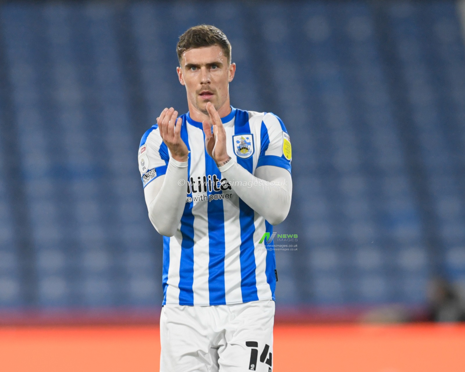 Josh Ruffels #14 of Huddersfield Town applauds the home supporters at the end of the game after his side beat West Bromwich Albion 1-0