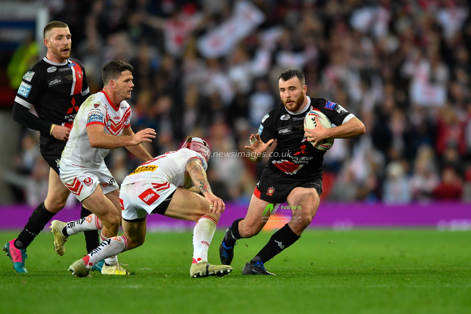 12th October 2019, Old Trafford, Manchester, England; The Grand Final 2019, Saint Helens v Salford Red Devils : Jake Bibby (5) of Salford Red Devils looks for a way through the Saint Helens defensive line

Credit: Simon Whitehead/News Images
