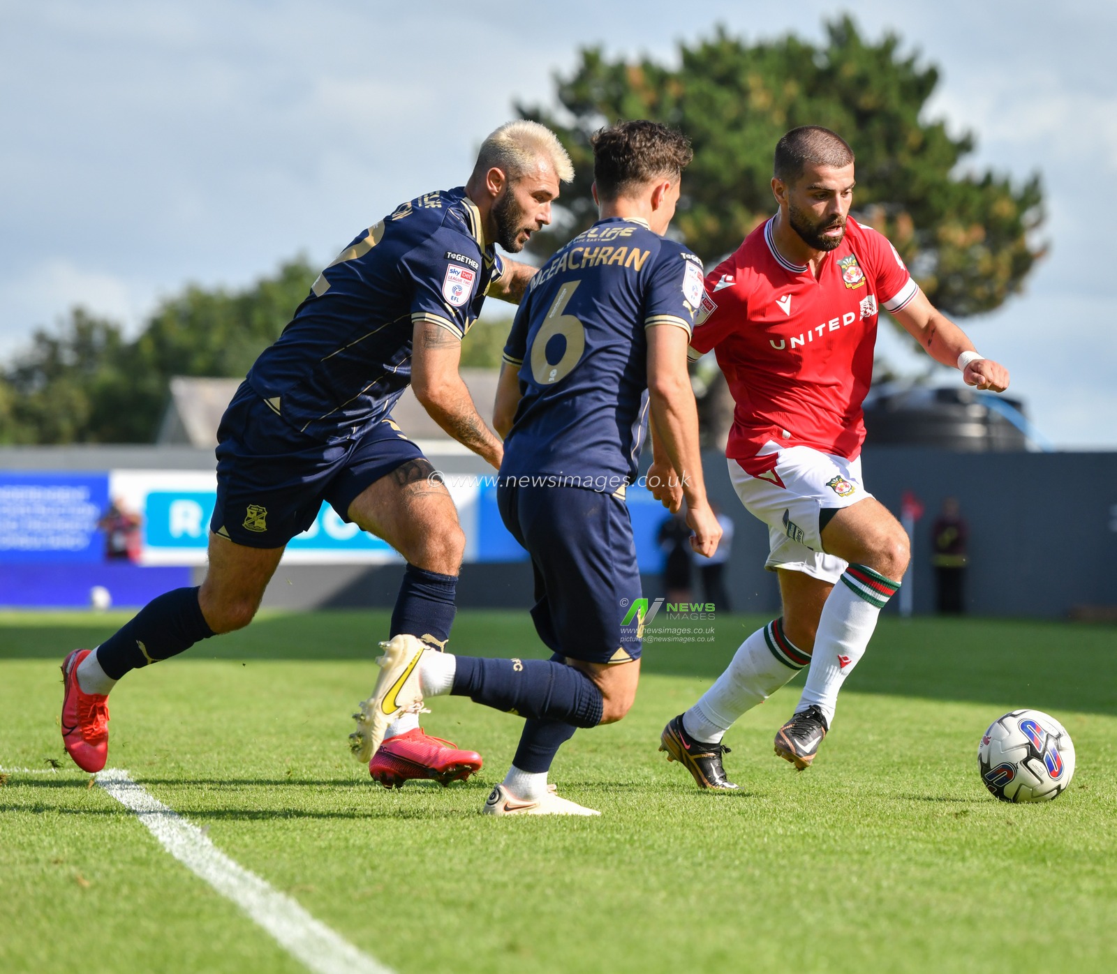 Wrexham's Elliot Lee drives the ball forward, during the Sky Bet League 2 match Wrexham vs Swindon Town at The Racecourse Ground, Wrexham, United Kingdom, 19th August 2023

(Photo by Cody Froggatt/News Images)